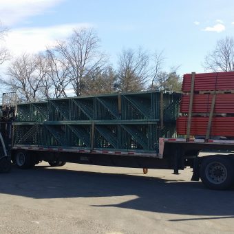 Flatbed truck loaded with teardrop uprights and teardrop beams